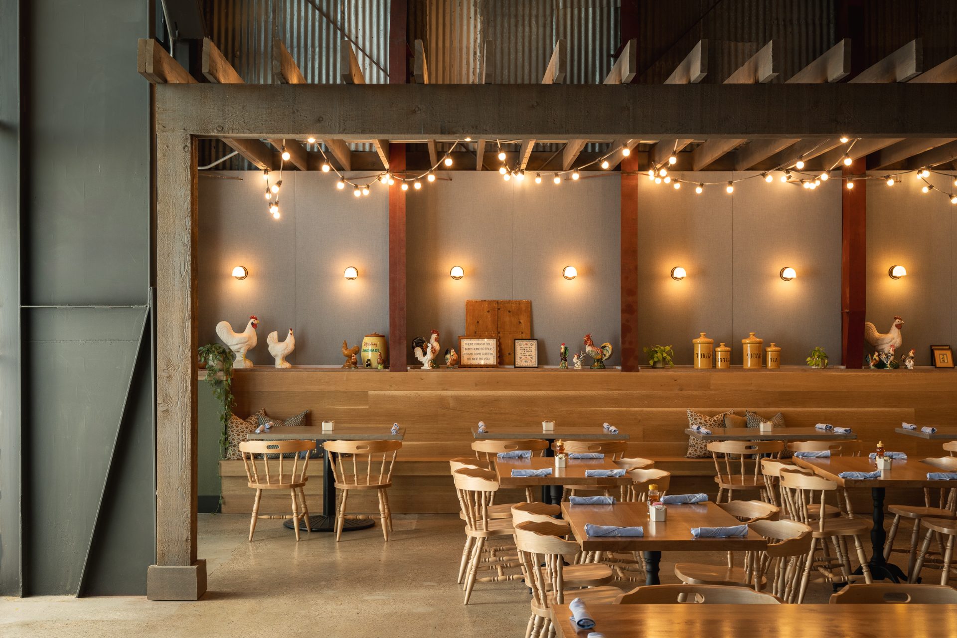 Roxie's at Buda Mill, dining area with timber beams and string lights